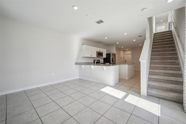 unfurnished living room featuring light tile patterned floors