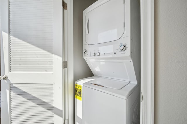 washroom with stacked washer / drying machine