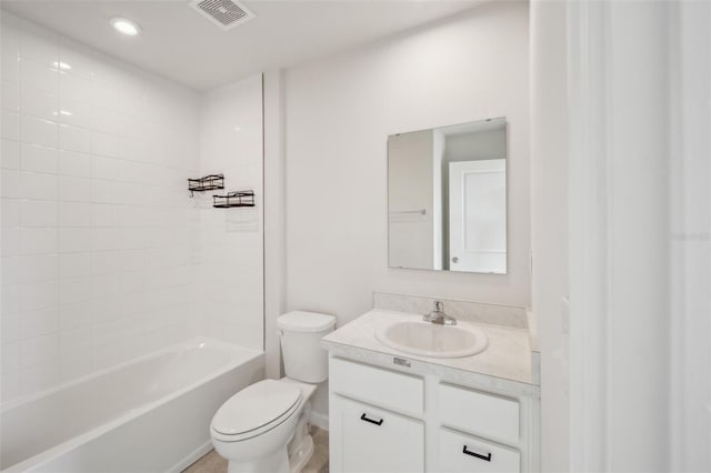 full bathroom with tiled shower / bath combo, vanity, and toilet