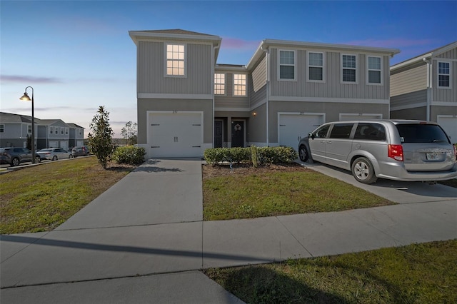 view of front facade with a garage and a yard