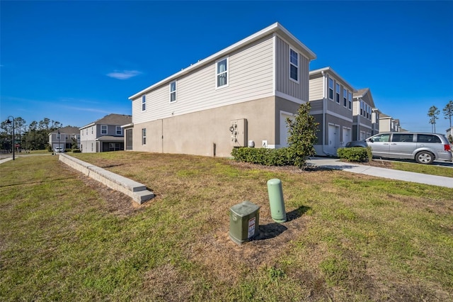 view of property exterior with a lawn