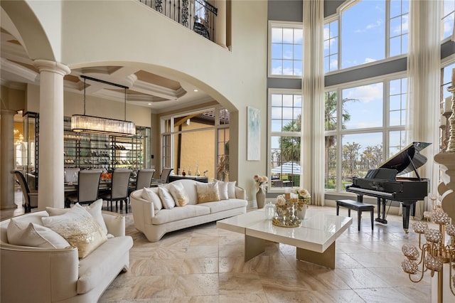 interior space with coffered ceiling, a high ceiling, and a notable chandelier