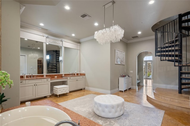 bathroom with tile patterned flooring, vanity, an inviting chandelier, and crown molding