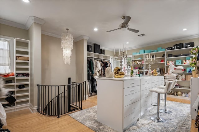 spacious closet featuring ceiling fan and light hardwood / wood-style flooring