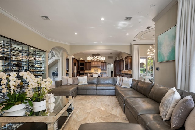 living room with an inviting chandelier and ornamental molding