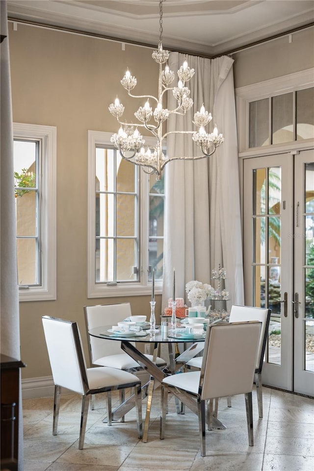 dining space featuring an inviting chandelier and french doors