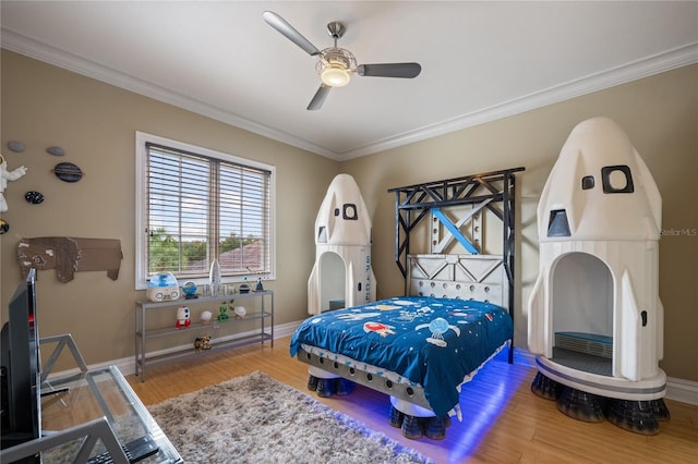 bedroom with hardwood / wood-style floors, ceiling fan, and crown molding