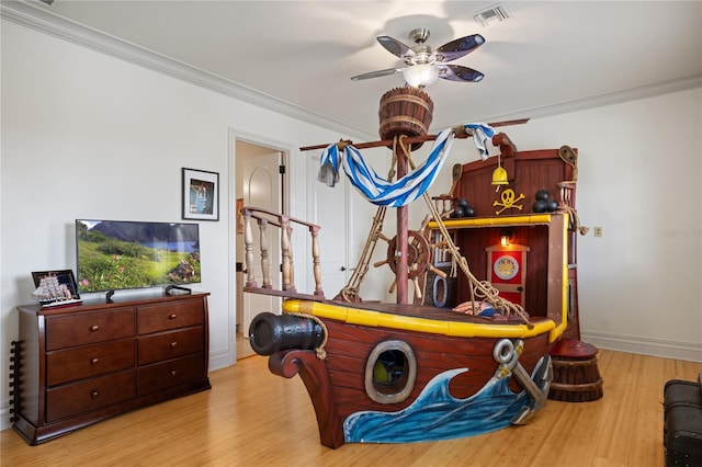 playroom with light hardwood / wood-style flooring, ceiling fan, and crown molding