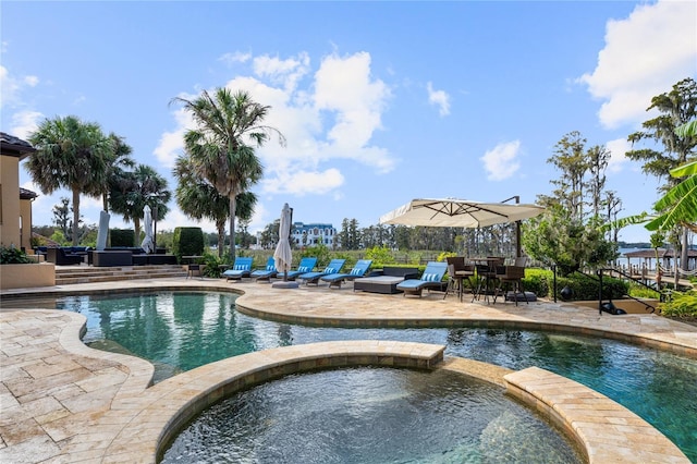 view of swimming pool with an in ground hot tub and a patio