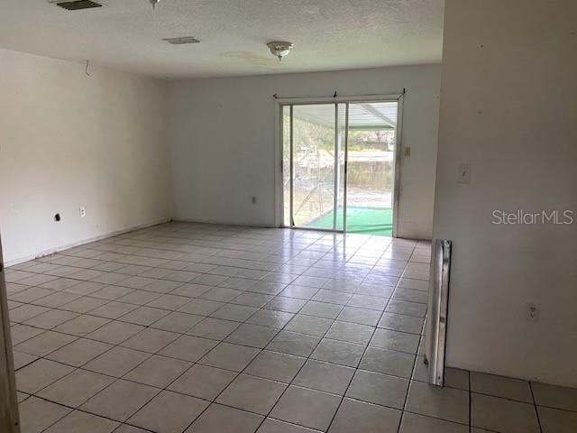 empty room with light tile patterned flooring