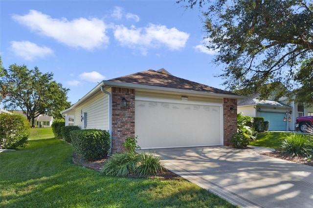 view of home's exterior featuring a garage and a lawn