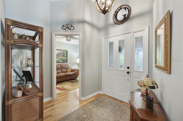 foyer with ceiling fan and light wood-type flooring