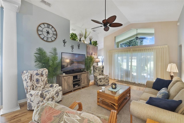 living room with ceiling fan, light hardwood / wood-style flooring, high vaulted ceiling, and decorative columns