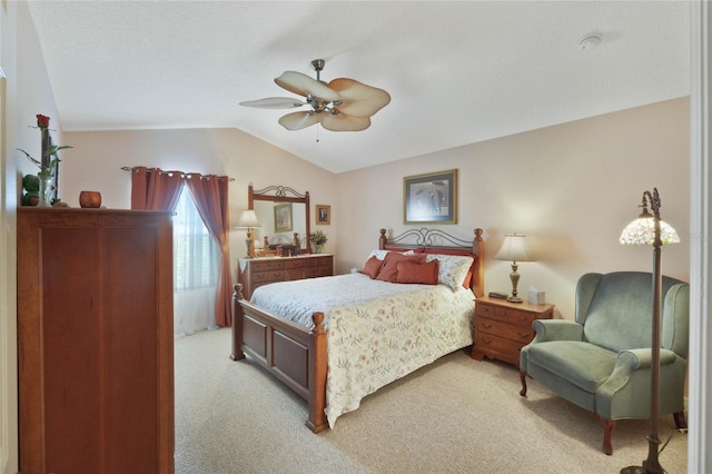 bedroom with ceiling fan, light colored carpet, and vaulted ceiling