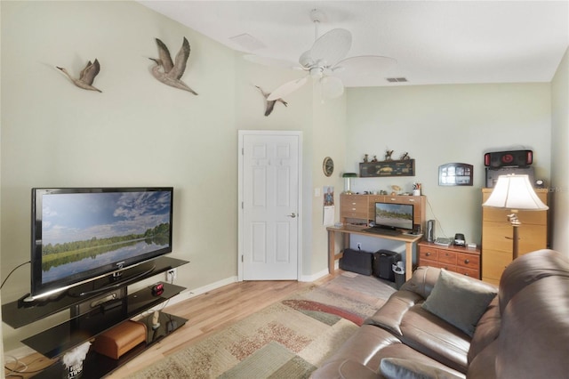 living room featuring ceiling fan and light wood-type flooring