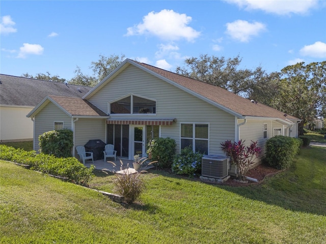 rear view of house with a lawn, central AC unit, and a patio