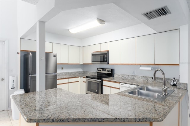 kitchen featuring sink, white cabinets, kitchen peninsula, stainless steel appliances, and light stone countertops