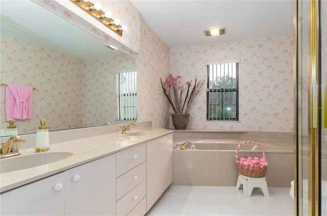 bathroom featuring tile patterned flooring, vanity, and a tub to relax in