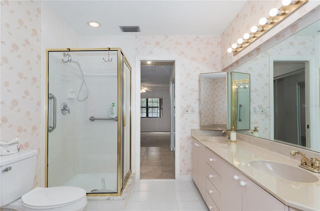 bathroom featuring vanity, toilet, a shower with shower door, and tile patterned flooring