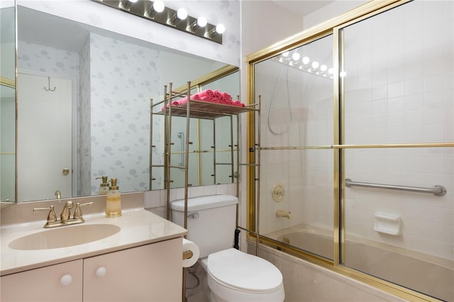 full bathroom with enclosed tub / shower combo, vanity, toilet, and wallpapered walls