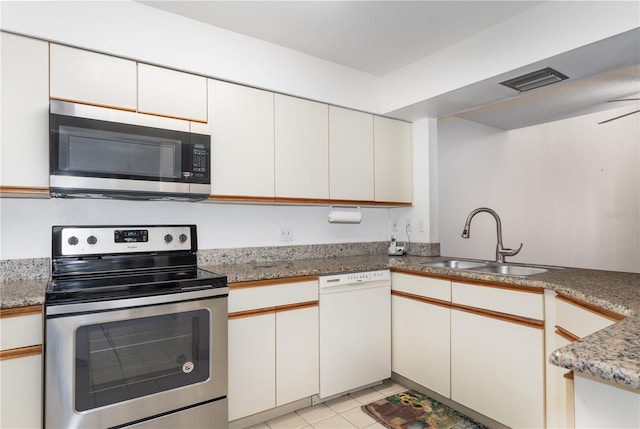 kitchen featuring appliances with stainless steel finishes, sink, and white cabinets