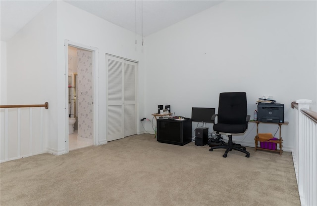 carpeted office space with vaulted ceiling