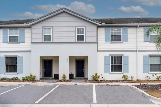 7424 Oakmoss Loop, Davenport, FL 33837 - townhome / multi-family property with uncovered parking and stucco siding