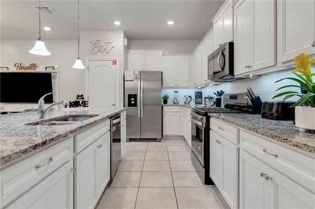7424 Oakmoss Loop, Davenport, FL 33837 - kitchen with stainless steel appliances, white cabinetry, tasteful backsplash, and recessed lighting