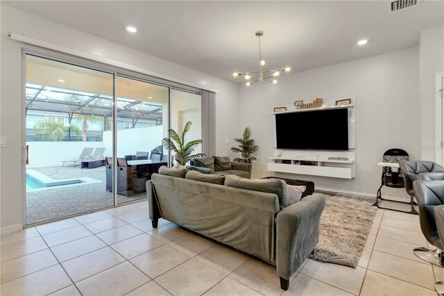 7424 Oakmoss Loop, Davenport, FL 33837 - living room featuring light tile patterned flooring, a chandelier, and recessed lighting