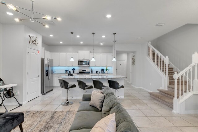 7424 Oakmoss Loop, Davenport, FL 33837 - living area with light tile patterned floors, stairway, recessed lighting, and a chandelier