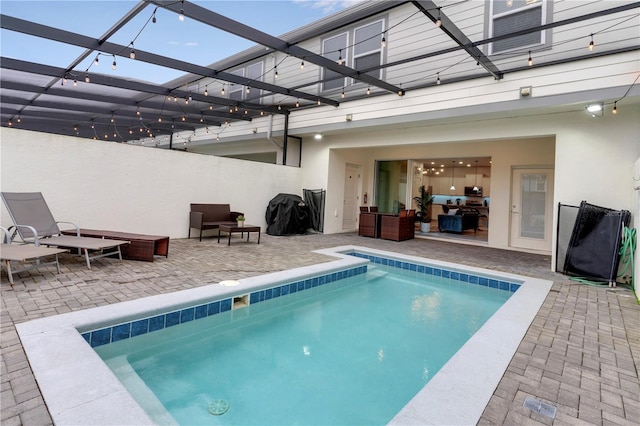 view of pool featuring a patio area and a lanai