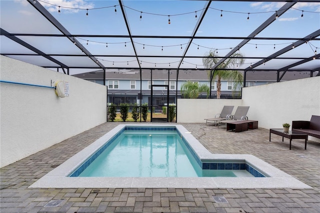 view of swimming pool with a lanai and a patio