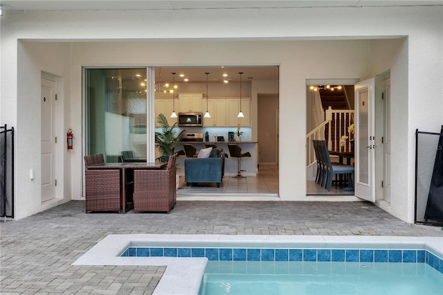 view of swimming pool featuring a jacuzzi