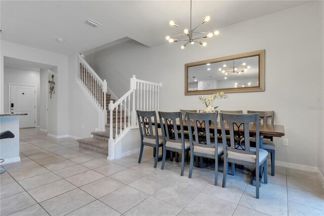 7424 Oakmoss Loop, Davenport, FL 33837 - dining area with light tile patterned floors, a chandelier, and stairway