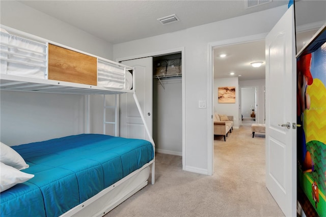 carpeted bedroom with a closet