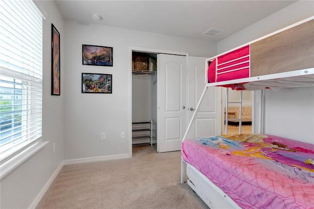 carpeted bedroom featuring a closet