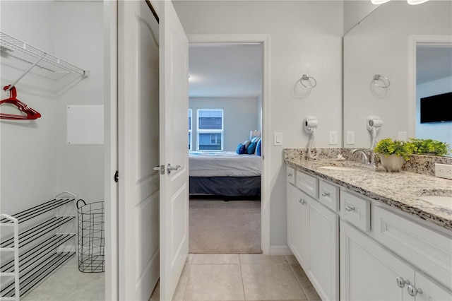 bathroom with tile patterned floors and vanity