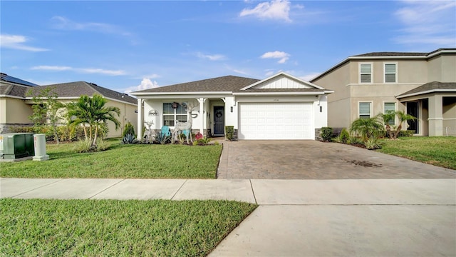 view of front of property featuring a garage and a front lawn