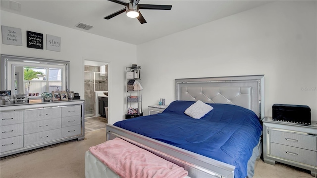 bedroom featuring ensuite bathroom, ceiling fan, and light colored carpet