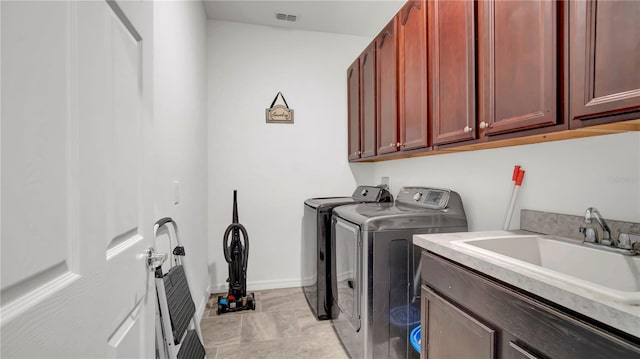 laundry room with light tile patterned flooring, cabinets, independent washer and dryer, and sink