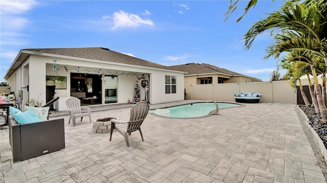 view of swimming pool featuring an outdoor fire pit and a patio