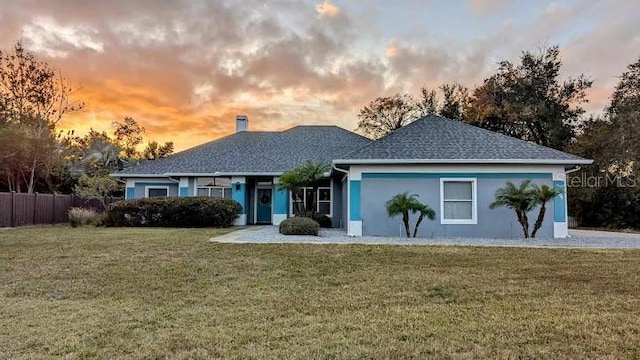 single story home featuring a yard