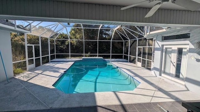 view of pool with ceiling fan, a lanai, a patio, and french doors