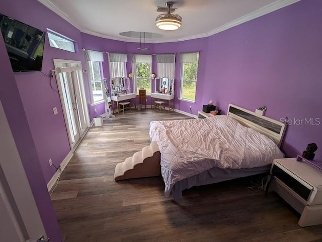 bedroom featuring ceiling fan, ornamental molding, and hardwood / wood-style flooring