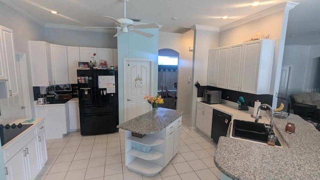 kitchen with white cabinets, sink, a kitchen island, and black appliances