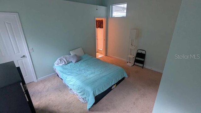 bedroom featuring light carpet