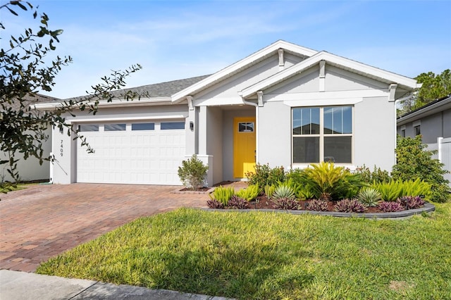 view of front of property with a garage and a front lawn