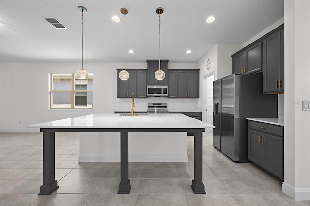 kitchen with gray cabinets, sink, hanging light fixtures, and appliances with stainless steel finishes