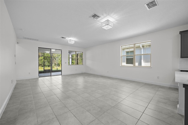 unfurnished room with light tile patterned floors