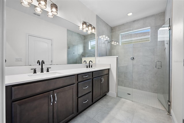 bathroom featuring tile patterned floors, vanity, and an enclosed shower